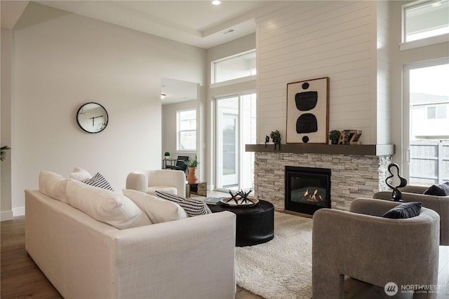 25708 64th Avenue Ct E Unit 4, Graham, WA 98338 - living area with wood finished floors, a fireplace, a towering ceiling, baseboards, and recessed lighting