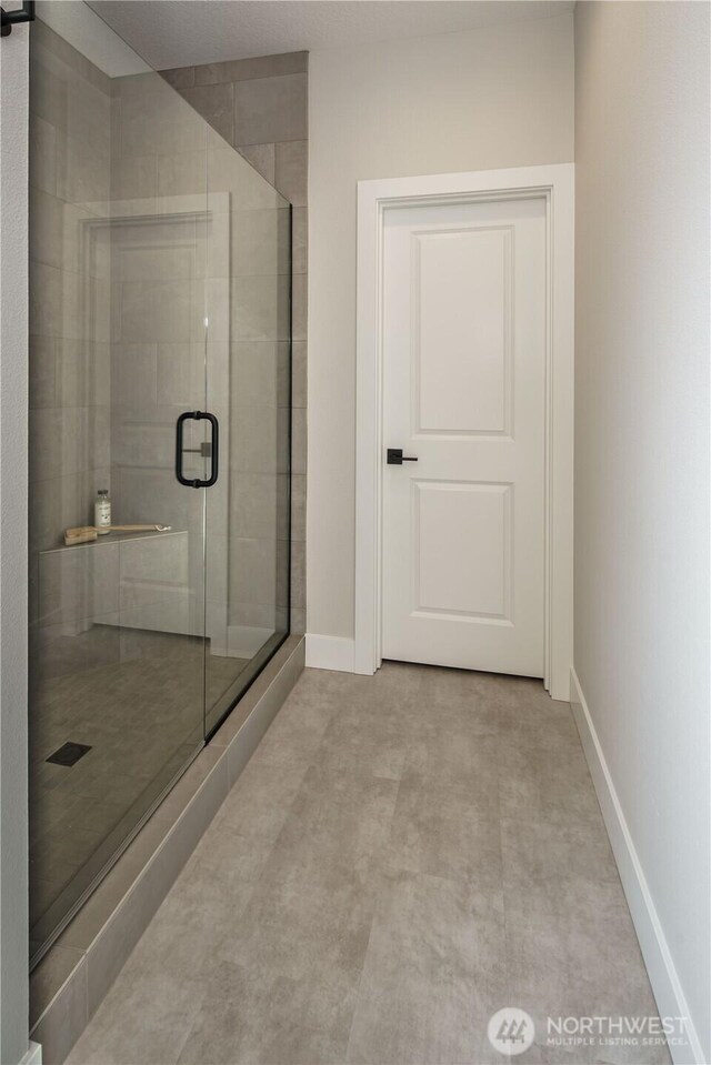 25708 64th Avenue Ct E Unit 4, Graham, WA 98338 - bathroom with a stall shower and baseboards
