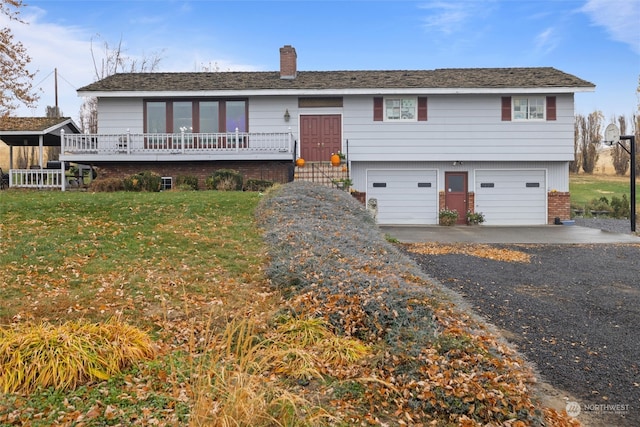 view of front of property featuring a garage and a front lawn