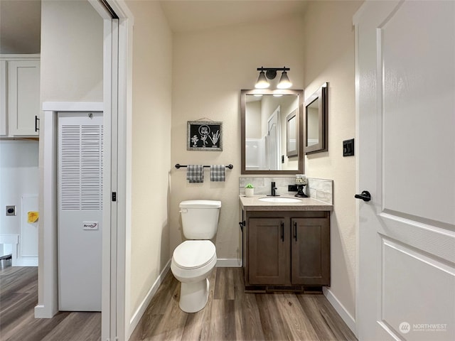 bathroom featuring hardwood / wood-style floors, vanity, and toilet