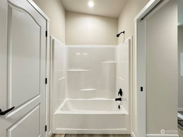 bathroom with hardwood / wood-style floors and shower / bath combination