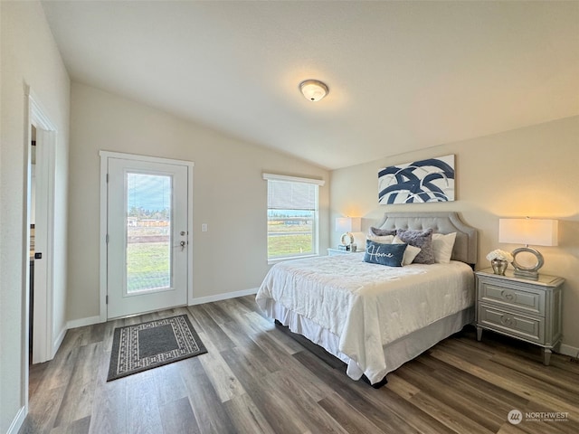 bedroom featuring access to outside, dark hardwood / wood-style flooring, and lofted ceiling