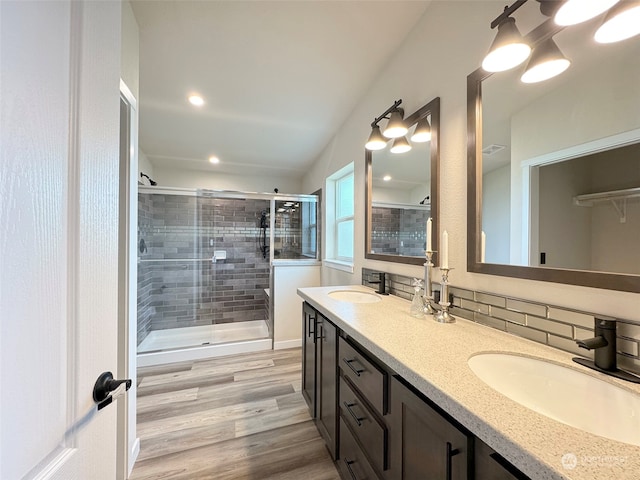 bathroom featuring wood-type flooring, vanity, and a shower with door