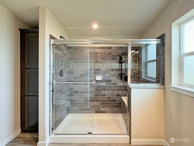 bathroom with a shower with door