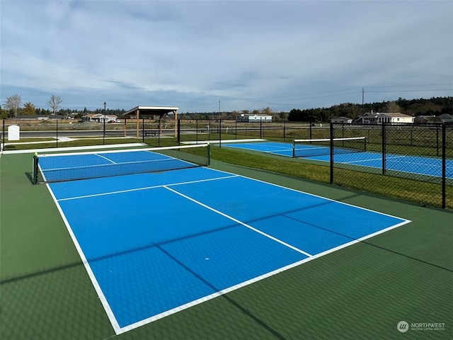 view of tennis court with basketball hoop