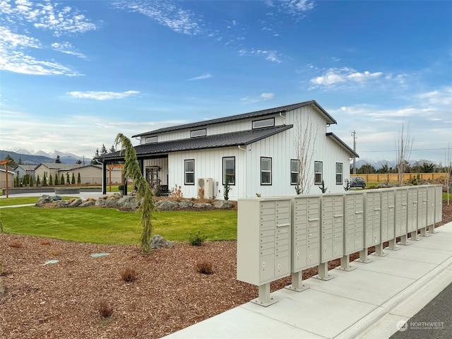 view of property's community featuring a yard and a mail area