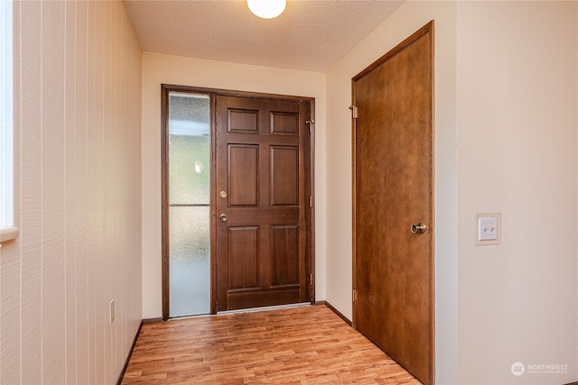 entryway featuring a textured ceiling and light wood-type flooring