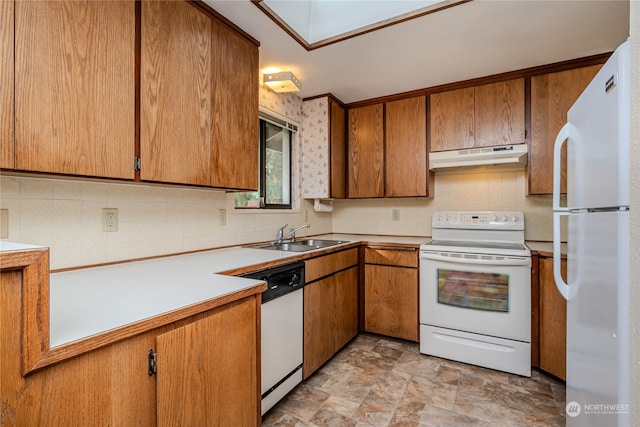 kitchen featuring sink, white appliances, and backsplash