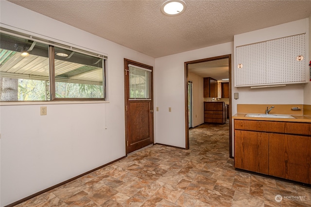 interior space with sink and a textured ceiling