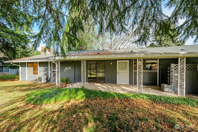 rear view of house featuring ac unit