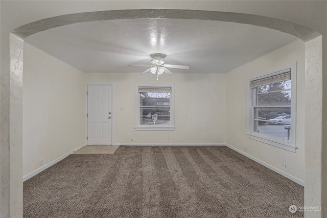 spare room with ceiling fan and carpet floors