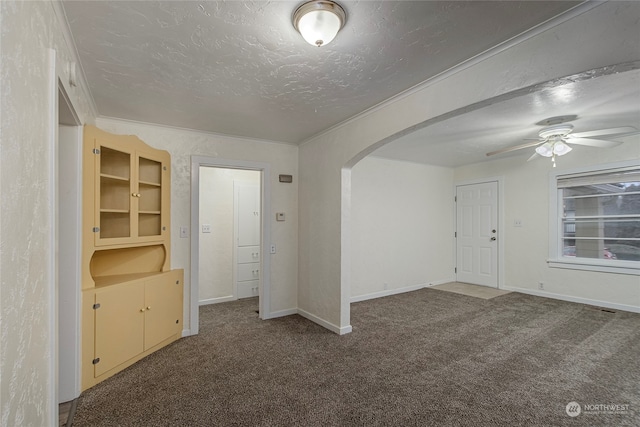 unfurnished room featuring carpet flooring, ceiling fan, crown molding, and a textured ceiling