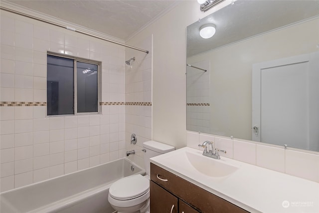 full bathroom with tiled shower / bath, vanity, a textured ceiling, and toilet