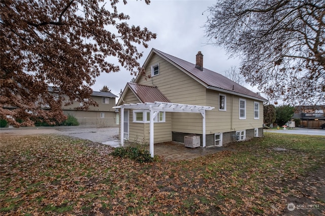 view of home's exterior with a pergola