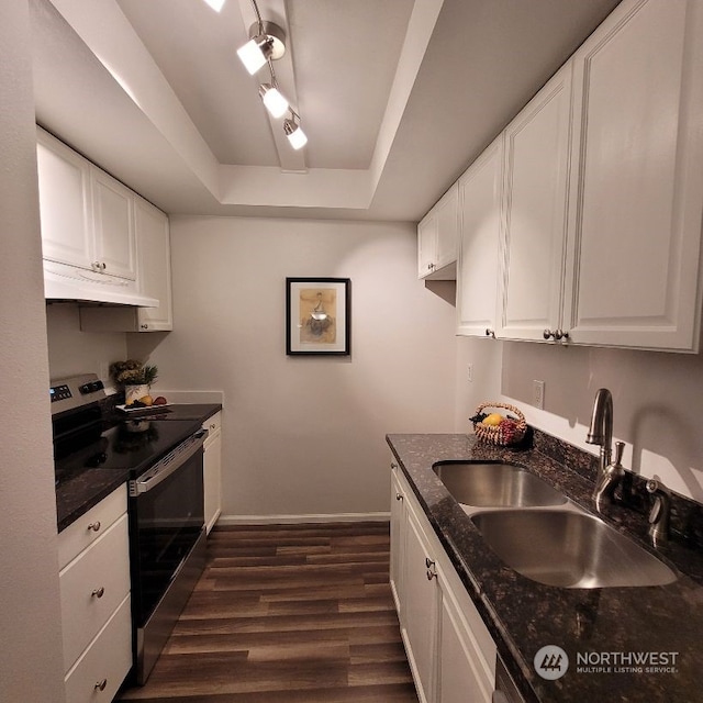 kitchen with stainless steel range with electric stovetop, white cabinets, sink, a tray ceiling, and dark hardwood / wood-style flooring