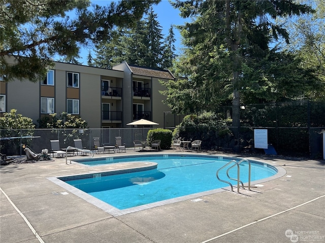 view of swimming pool featuring a patio area