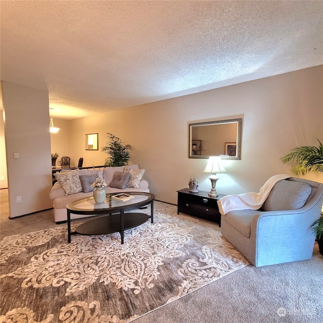 carpeted living room featuring a textured ceiling