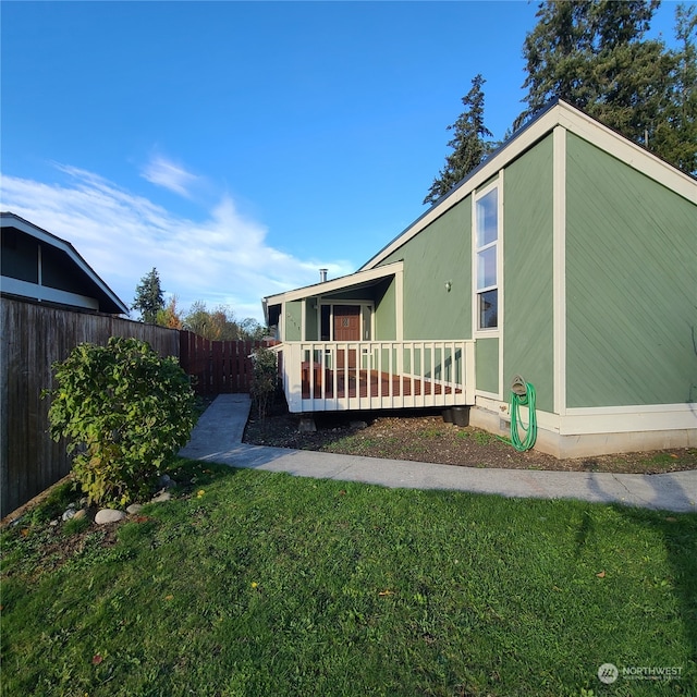 rear view of property featuring a lawn