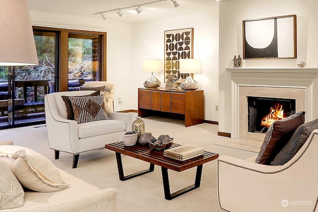 sitting room with light carpet and track lighting