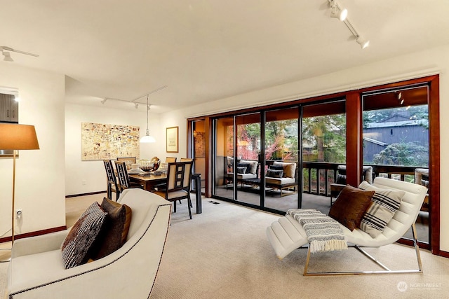 living room featuring light colored carpet and rail lighting