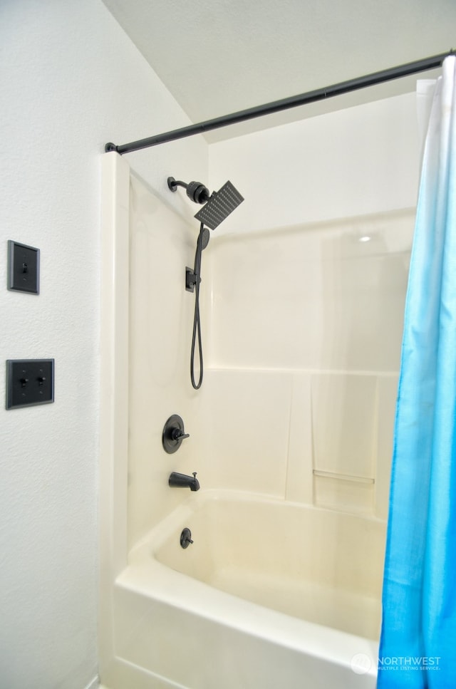 bathroom featuring shower / tub combo with curtain