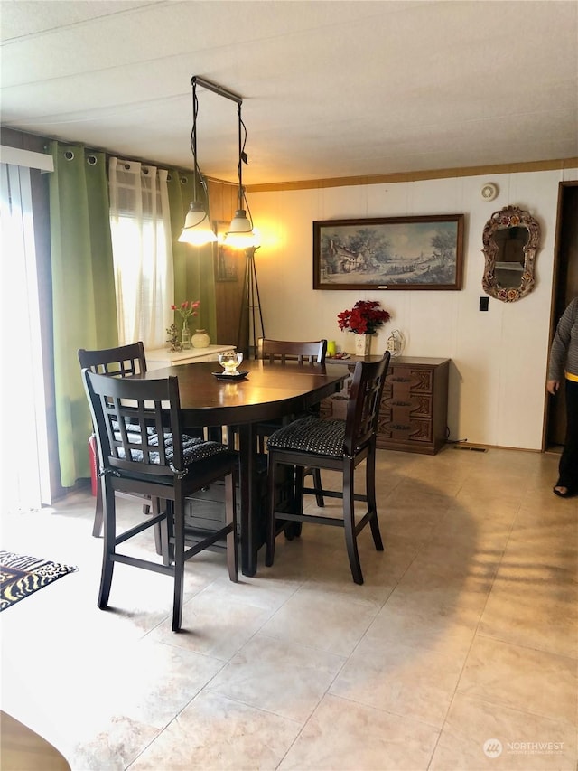 dining space featuring crown molding