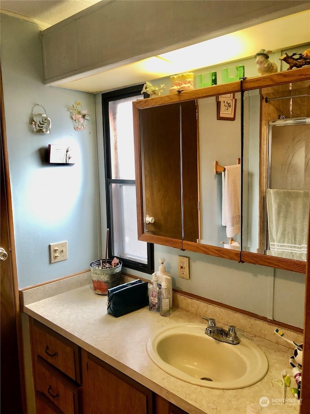 bathroom featuring vanity and an enclosed shower