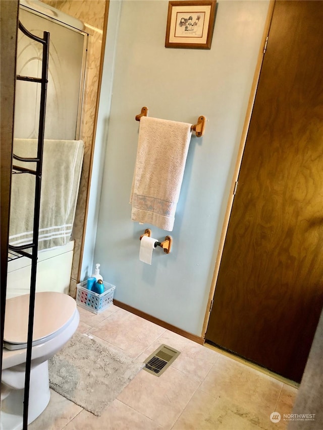 bathroom featuring tile patterned floors and toilet