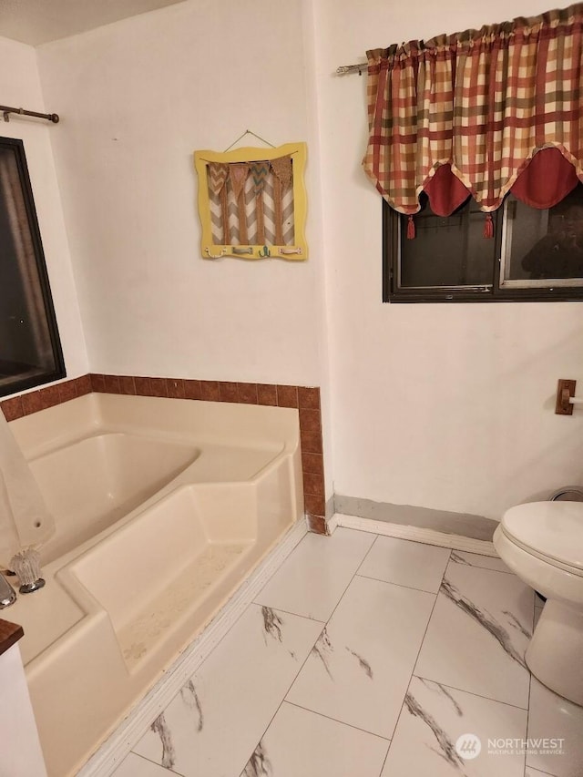 bathroom with a bath and toilet