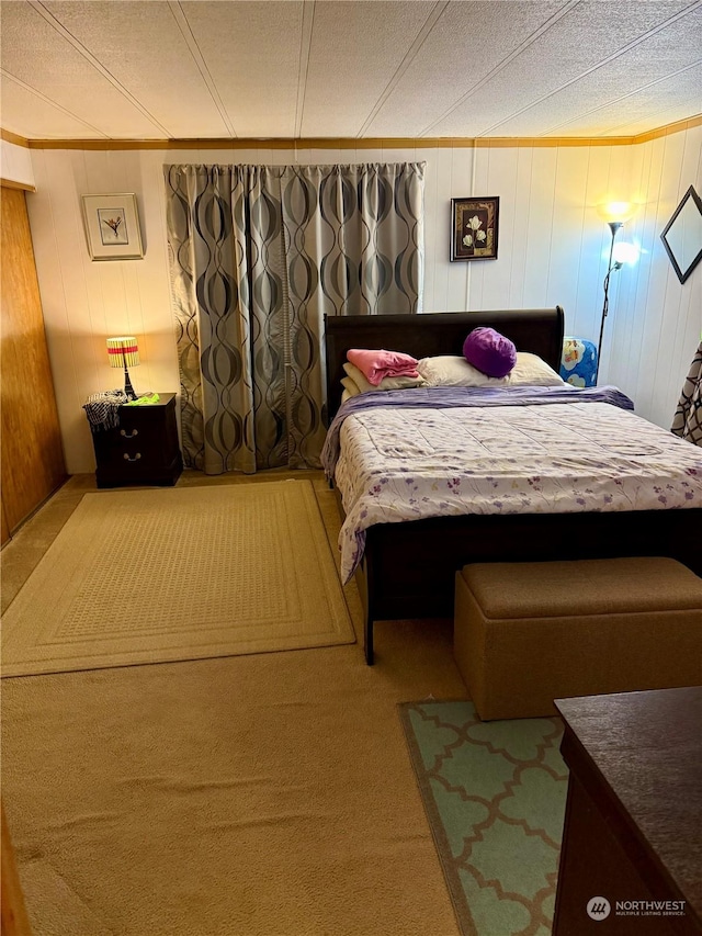 bedroom featuring crown molding and carpet flooring