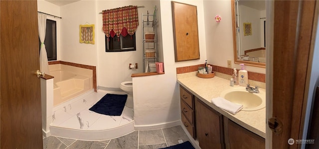 bathroom with vanity, toilet, and a bathing tub