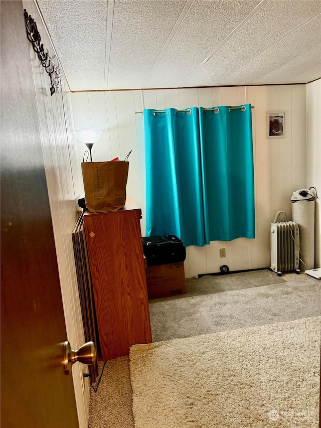 interior space with radiator and a textured ceiling