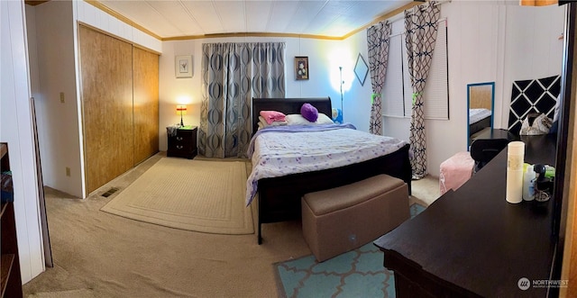 carpeted bedroom featuring ornamental molding