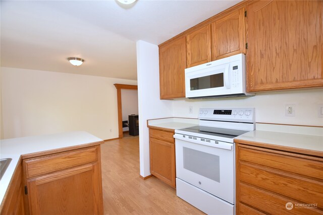 kitchen featuring white appliances and light hardwood / wood-style floors