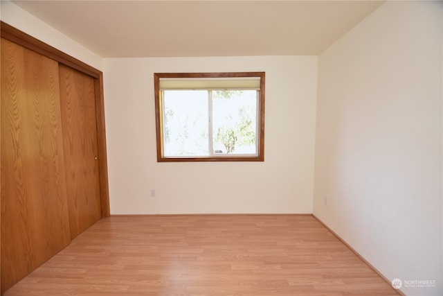 unfurnished bedroom featuring a closet and light hardwood / wood-style flooring