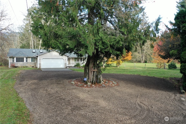 view of front of house featuring a garage and a front lawn