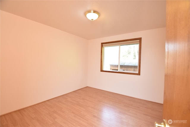 empty room with hardwood / wood-style flooring