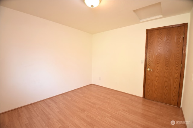 empty room with light hardwood / wood-style flooring