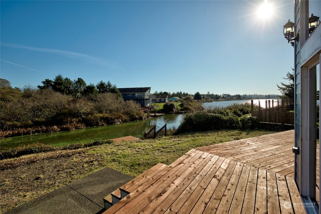 wooden terrace with a water view