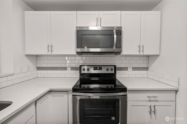 kitchen with appliances with stainless steel finishes and white cabinetry