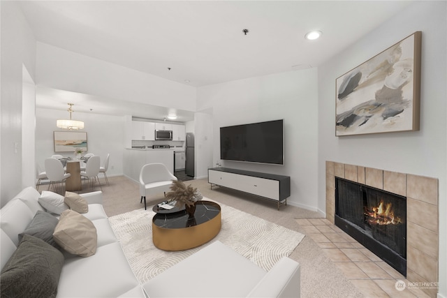 carpeted living room featuring a tile fireplace