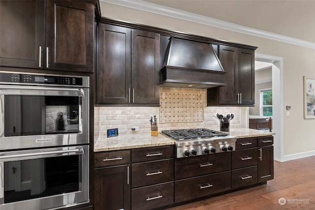 28330 318th Dr SE, Ravensdale, WA 98051 - kitchen with appliances with stainless steel finishes, premium range hood, crown molding, tasteful backsplash, and baseboards