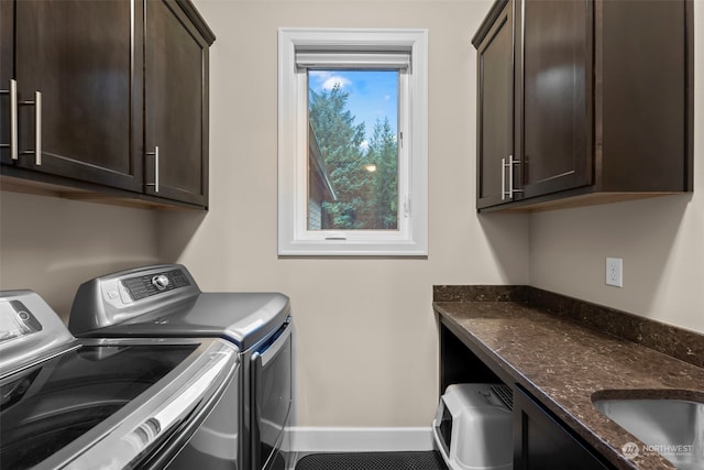 laundry area with cabinets, washer and clothes dryer, and sink