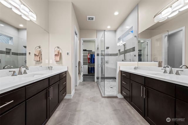 28330 318th Dr SE, Ravensdale, WA 98051 - bathroom with a shower stall, two vanities, a walk in closet, tile patterned flooring, and recessed lighting