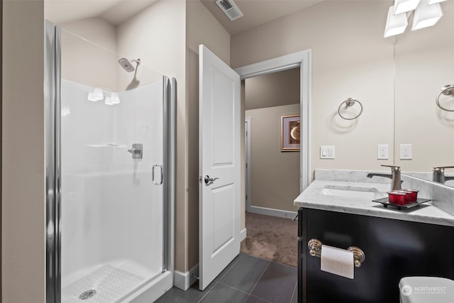 bathroom featuring tile patterned floors, vanity, and a shower with shower door