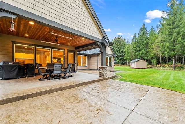 view of patio featuring area for grilling, ceiling fan, and a storage shed