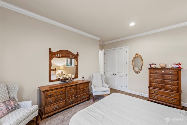 carpeted bedroom featuring ornamental molding and a closet