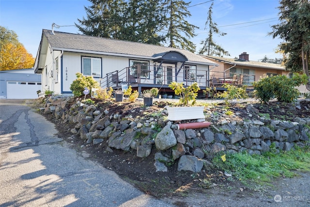 view of front of house featuring a garage and a wooden deck