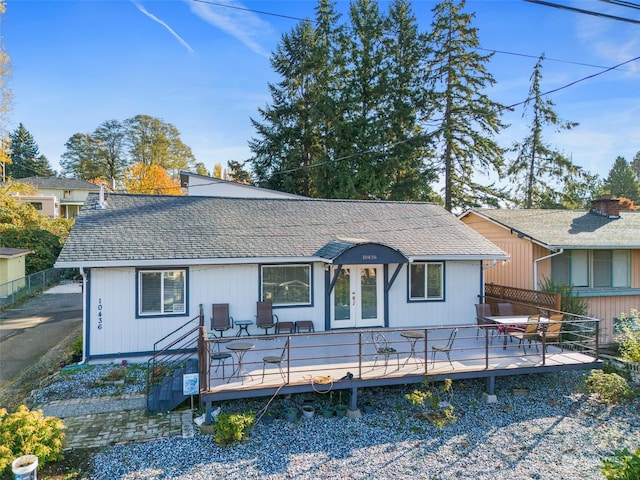 back of property featuring a deck and french doors