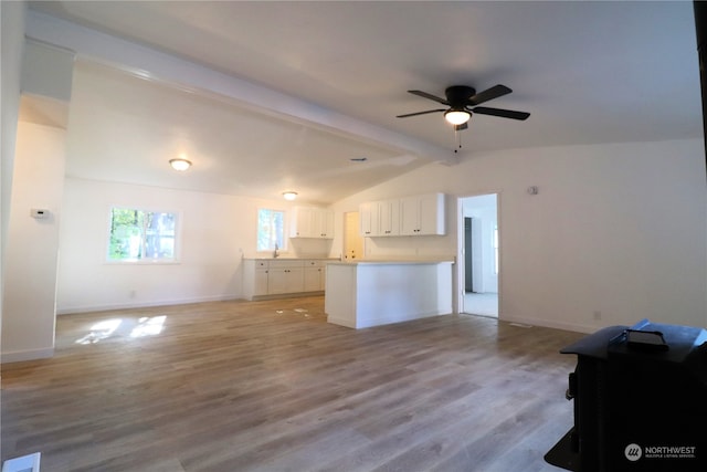 kitchen featuring vaulted ceiling with beams, ceiling fan, light hardwood / wood-style floors, and white cabinetry